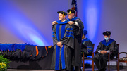 Lukas Farbiak, Ph.D., is hooded by Stuart Ravnik, Ph.D., Associate Dean of the Graduate School.