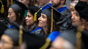 Denise Marciano, M.D., Ph.D., Associate Professor of Internal Medicine, watches the ceremony intently as commencement remarks are being made.