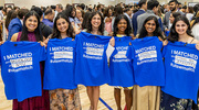 Medical school besties line up for a photo to show off their T-shirts proudly displaying where they matched.