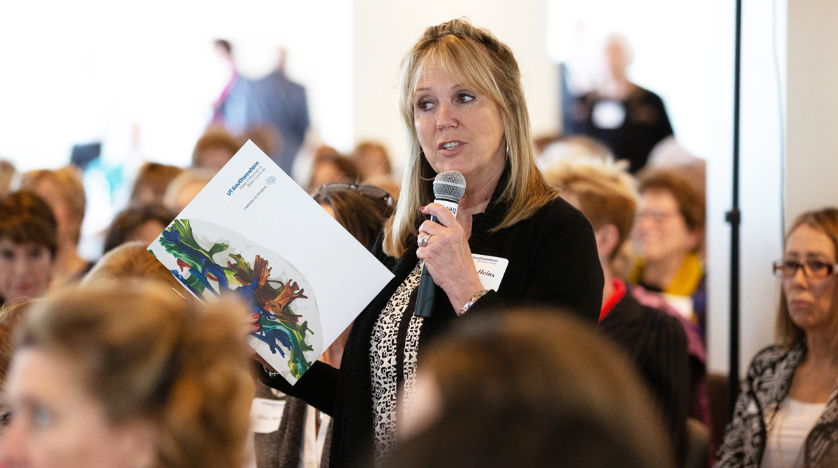 Attendee Shelly Heins asks a question at the Symposium.