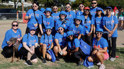 A team poses together in their heart-shaped sunglasses.