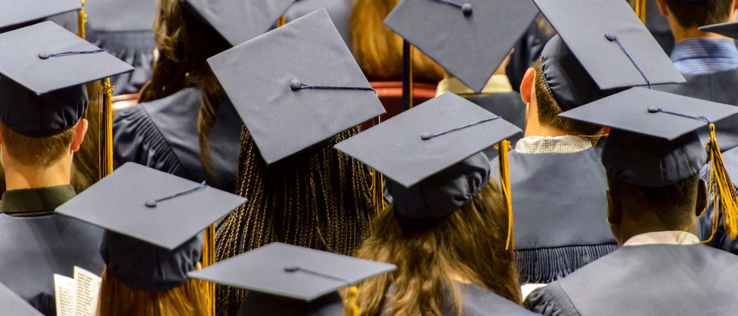 Graduating students wearing black caps and gowns