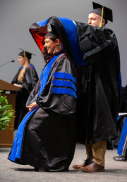 Dr. Varsha Bhargava is hooded by her mentor, Dr. Michael Buszczak