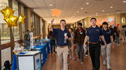 Physical therapy students Chase Haney, left, and Brock Stiles, front right, lead students to a breakout session at the symposium.