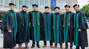A group of newly graduated physicians celebrate their hard-earned accomplishment.