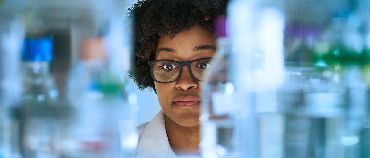 Woman in lab looking at bottles