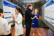 Medical students discuss their poster presentations.