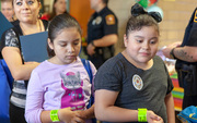 Health fair participants eye delicious choices at the Nutrition station.