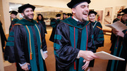 Class co-President Dr. Rudy Fernandez-Criado (front) is joined in celebration by other graduates, including Farzam Farahani (left).