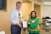 The Rev. John O’Neal, Director of Chaplain Services, presents Ms. Ali with a certificate for five years of service.