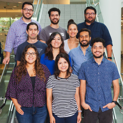 10 people standing on a stairwell smiling