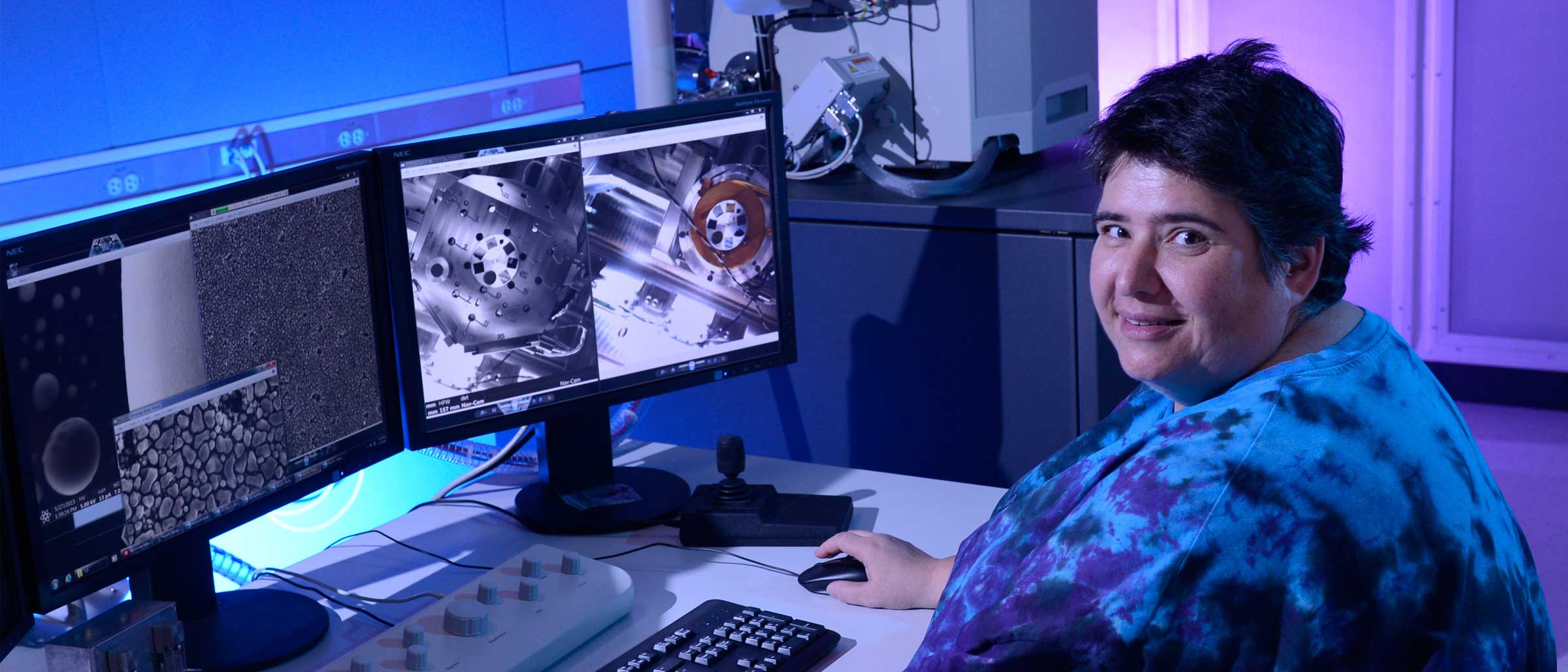 Woman with short dark hair sitting at computer