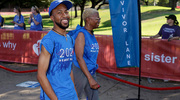 One walker smiles for the camera as he nears the finish.