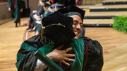 Alex Serna Castillon, M.D., receives a heartfelt hug after receiving his diploma.