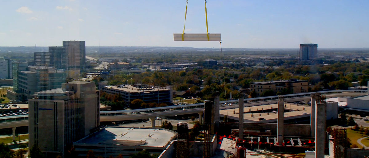 Beam being lowered onto building