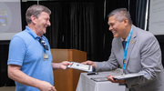 Michael Aiken of Media Technology receives his PACT certificate from David Nelson of the Employee Experience and Recognition team.