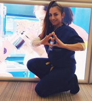Karen Olvera, William P. Clements Jr. University Hospital, poses on the second floor of the hospital. "I love the picture behind me because it shows my current job as a Clinical Lab Assistant, and I really love my job and the UT Southwestern community environment," she said.