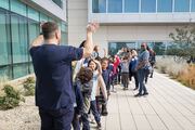 Students form a single file line to enter the Sim Center.