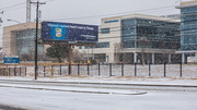 Snow falls along a deserted roadway on East Campus.