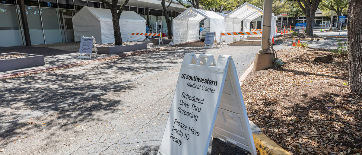 Sign about drive thru testing in front of tents