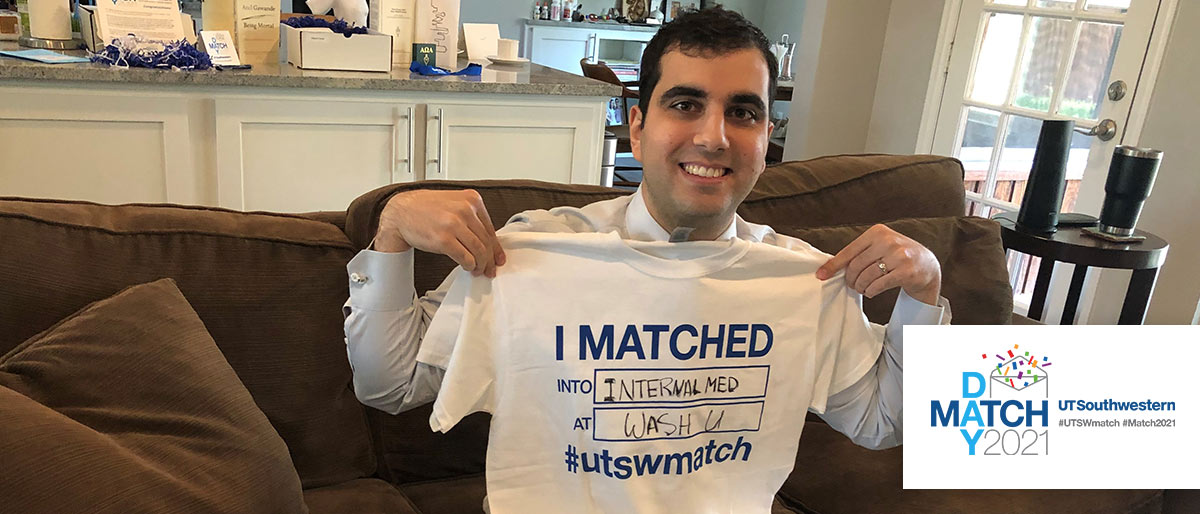 Man holding up shirt that says I matched into internal med at Wash U