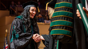 Adreanna Hernandez, M.D., is overjoyed as she crosses the stage to receive her degree.