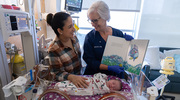 Neonatal Intensive Care Unit Nurse (NICU) Becky Scherer (right) shares a book with baby Mia and mother Steph Diaz at the Clements University Hospital NICU during the international Babies With Books Read-a-thon. The event offered NICUs across the world a friendly competition to see whose staff could read the most books to their littlest patients. Clements University Hospital nursing teams and families completed 154 reading sessions Sept. 11-21. NICU teams collected 293 new books for the project, all of which were donated during the campaign to patients’ families.