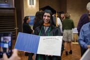 Physician Assistant Studies graduate Nina Nariman displays her diploma.