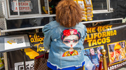 Melody Bell, wearing a Frida Kahlo inspired denim jacket, orders from Calios Tacos food truck.