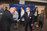 UT Southwestern President Dr. Daniel K. Podolsky shakes hands with Dallas artist John Pomara, a Professor in the School of Arts and Humanities at UT Dallas.