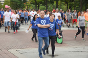 Two walkers make their way through downtown.