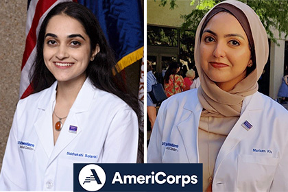 two women in white lab coats next to blue AmeriCorps logo