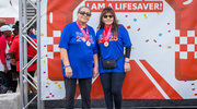 Two heart disease survivors show off their medals at the end of the walk.