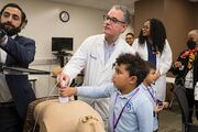 Daniel Scott, M.D., Director of the Simulation Center, shows Marcus Mobley how to use an ultrasound machine.