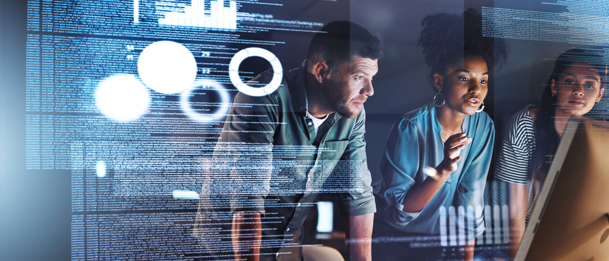 Three people standing in front of data display