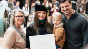 Doctor of Physical Therapy graduate Allisyn Hollingsworth shows off her new diploma alongside her family.