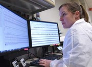 A medical technologist analyzes results from the Sanger sequencing. If the variant is confirmed, the lab will include it in a report for final review.