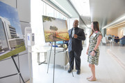 West Campus Building 3 Employees in Lobby Viewing Rendering