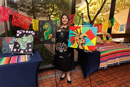 woman holding colorful paintings