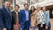 Sarah Prickett (tan jacket) poses for a photo with her husband and family before her match reveal.