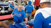 UTSW President Daniel K. Podolsky, M.D., hands out new bucket hats ahead of the walk.