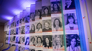The display wall features photos and profiles of 60 UT Southwestern female faculty members selected by a committee.