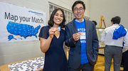 Shivani Raman and Edward Wen get ready to place their photos on the United States Match map board.