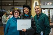 Physical Therapy graduate Michelle Chan shows off her diploma.