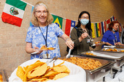 Employees help themselves to chicken tinga and tostadas.