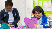 Serenity and Juan show intense concentration making their valentines perfect.