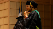 Kehinde Odedosu, M.D., Assistant Dean for Student Affairs, looks on with pride as students achieve the final milestone to begin their medical careers.
