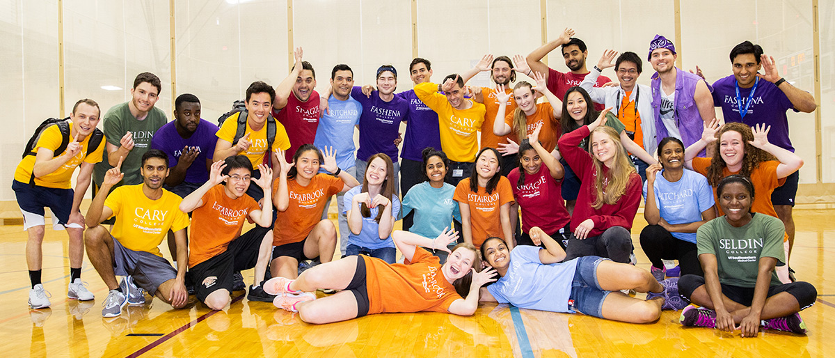 students in different color t-shirts that represent their colleges