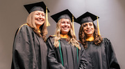 Master of Physician Assistant Studies graduate Samantha Anderson, center, smiles with program faculty after receiving her diploma.