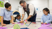 Art teacher James Fries shows the students the best technique to make the perfect valentine.